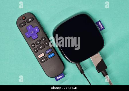 Houston, Texas USA 05-01-2024: Roku streaming media player remote control blue background. Stock Photo