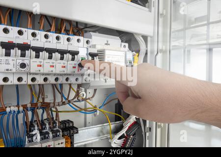 Hand Operating Switch in Electrical Circuit Panel Stock Photo
