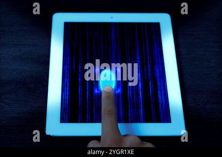 Man using fingerprint scanner in tablet by touching it, closeup Stock Photo