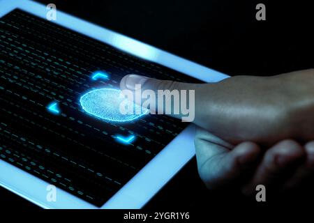 Man using fingerprint scanner in tablet by touching it, closeup Stock Photo