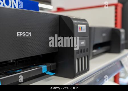 Epson logo on a printer close-up. Epson printer on a shelf in an electronics and computer store. Minsk, Belarus - November 6, 2024 Stock Photo