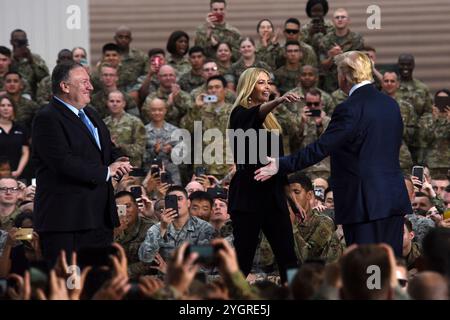 Pyeongtaek, South Korea. 30 June, 2019. U.S President Donald J. Trump, right, embraces his daughter Ivanka Trump, center, as Secretary of State Mike Pompeo, left, looks on during a visit with service members at Osan Air Base, June 30, 2019, Pyeongtaek, Gyeonggi Province, South Korea.  Credit: SSgt. Sergio Gamboa/US Army Photo/Alamy Live News Stock Photo