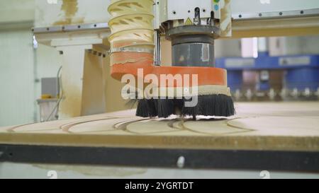 The machine cuts a drawing on a wooden facade. The CNC machine is working. Close-up of a numerical control machine cuts a tree. CNC tool. Stock Photo