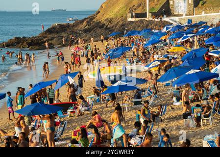 Salvador, Bahia, Brazil - December 21, 2019: View of the beach of Porto da Barra crowded with tourists and bathers during sunset in the summer of Salv Stock Photo