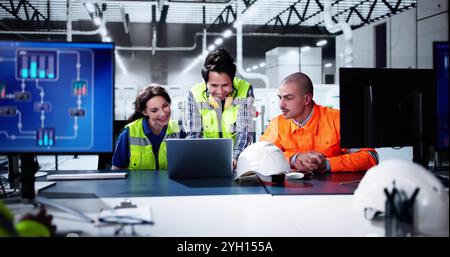 Factory Automation Using Scada System. Diverse Workers Using Control Computers Stock Photo