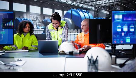 Oil And Gas Automation. Diverse Workers Using Control Computers Stock Photo
