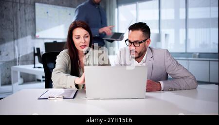 Modern Business People Discussing Work In Office And Using Laptop Together While Working. Stock Photo