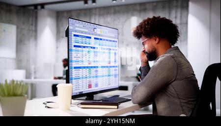 Data Analyst African Man Using Spreadsheet On Computer Stock Photo