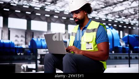 Oil And Gas Power Plant Worker Using Laptop Computer Stock Photo