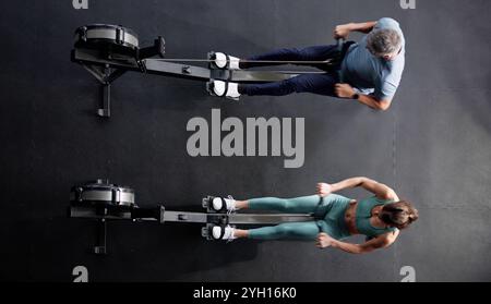 High Angle View OF Woman In Gym Using Rowing Machine For Training Stock Photo