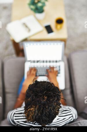Typing, online and person with laptop, home and video editing for digital campaign, website and above. Living room, research and content creation for Stock Photo