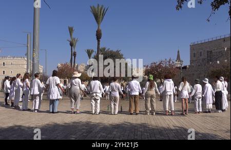 JERUSALEM - NOVEMBER 8: Israeli female peace activists dressed in white gather for a sit-in demonstration in front of the old city calling for a ceasefire and diplomatic solution to the ongoing war in Gaza and Lebanon on November 8, 2024 in Jerusalem. Israel Stock Photo