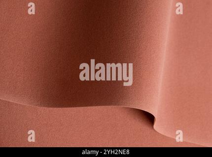 Designer paper background with a warm, velvety texture in rich earthy tones of terracotta, copper, and ochre. This abstract, minimalistic surface feat Stock Photo