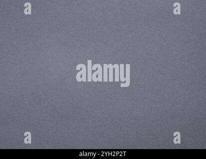 Designer paper background with a smooth, matte texture in rich charcoal gray. This minimalist, monochrome surface provides a clean and elegant backdro Stock Photo