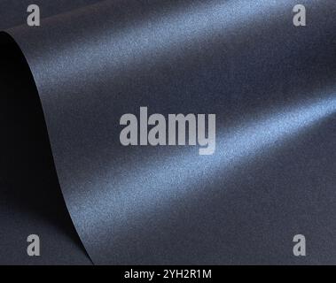Glossy designer paper background with a deep navy blue gradient and a cool, metallic satin finish. This sophisticated surface features wavy, curved la Stock Photo