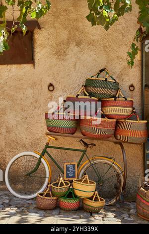 Still life of a bicycle and baskets in the village of Moustiers Sainte Marie in the Provence-Alpes-Côte d'Azur region of south eastern France. Stock Photo