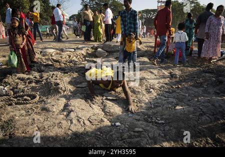 Hindu devotees perform rituals as they offer prayers to the Sun god in the bank of Brahmaputra river on the occasion of the 'Chhath Puja' festival in Stock Photo