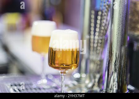 Two beer glasses in the tap of a pub Stock Photo