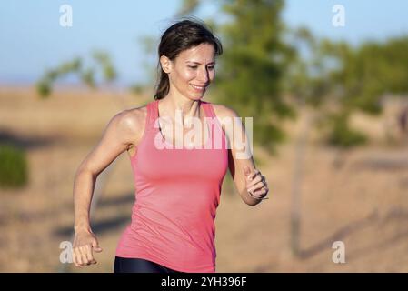 Fitness woman running in the park Stock Photo