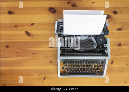 Old retro typewriter on wooden desk Stock Photo