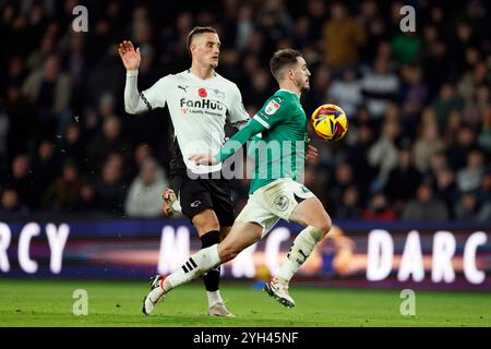 Derby County's Jerry Yates and Plymouth Argyle's Julio Pleguezuelor (right) battle for the ball during the Sky Bet Championship match at Pride Park, Derby. Picture date: Saturday November 9, 2024. Stock Photo