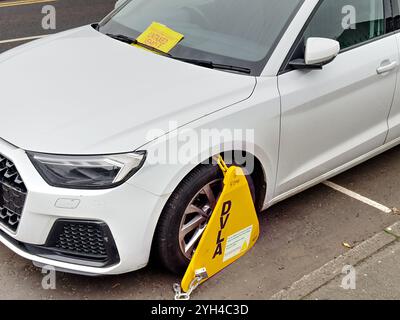 Car wheel clamped due to vehicle being untaxed Stock Photo