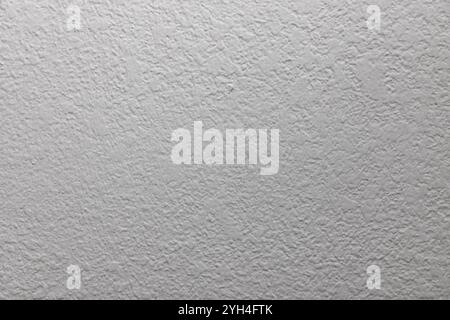 white background with copy space and a stucco texture in grayscale, midtones and highlights. Stock Photo
