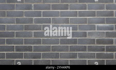 gray brick wall with white cement joints as graphic resource and background texture, with empty copy space, plain wall made of smooth bricks Stock Photo