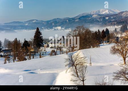 Early morning mist over a snowy landscape in a rural, mountainous area Stock Photo