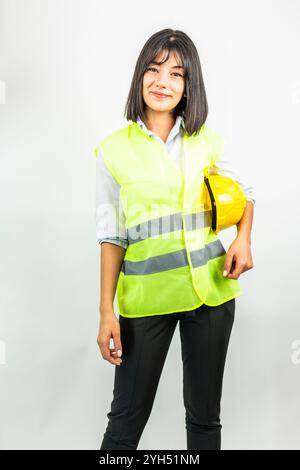 engineer woman holding a yellow hard hat Stock Photo