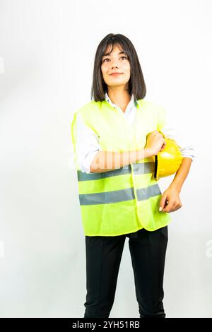 engineer woman holding a yellow hard hat Stock Photo