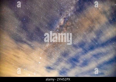 Blurred long exposure clouds and distant Milky Way in Southern Hemisphere from Australia. Stock Photo