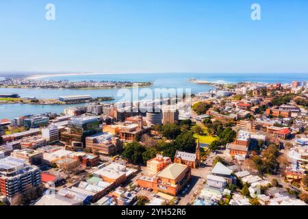 Hunter river entering pacific ocean at Newcastle city CBD in aerial cityscape view in Australia. Stock Photo