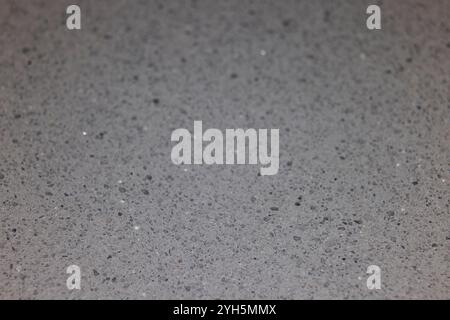 close up macro of granite countertop texture, smooth polished rock, small stones and flecks with copy space and selective focus Stock Photo