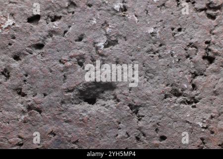 Close up of a extremely rough textured background with shadows in pink, brown, gray, black. Close up with copy space Stock Photo
