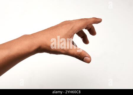Outstretched hand of a Latino man with open fingers, isolated on white background. Stock Photo