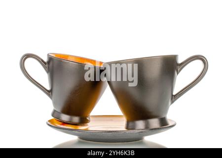 Two ceramic cups and saucers, macro, isolated on white background. Stock Photo