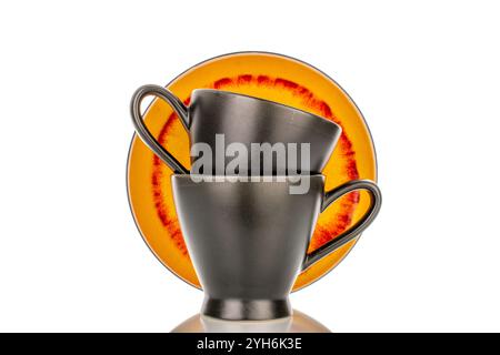 Two ceramic cups and saucers, macro, isolated on white background. Stock Photo