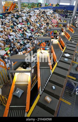 ZAOZHUANG, CHINA - NOVEMBER 10, 2024 - Staff sort express deliveries at the network operation center of the delivery division of China Post Group Co L Stock Photo