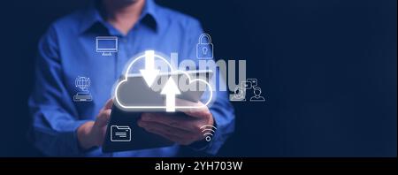 Cloud computing concept. A man using cloud computing service on a tablet to enable access to files and stay connected with friends safely over the int Stock Photo