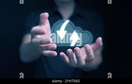 Cloud computing concept. A man using cloud computing service in his hands to access and manage files and resources over the internet Stock Photo