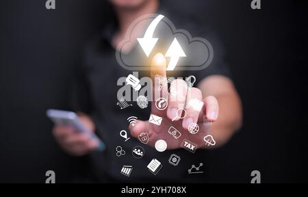 Cloud computing concept. A man using cloud computing service to enable access to files, services, and other resources safely over the internet Stock Photo
