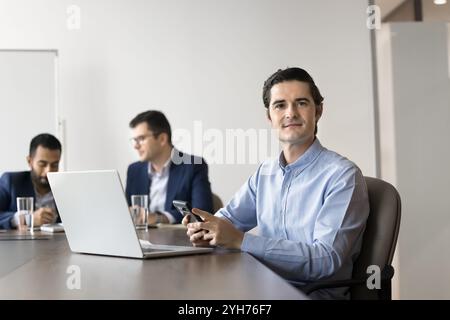 Positive confident business leader man using smartphone Stock Photo