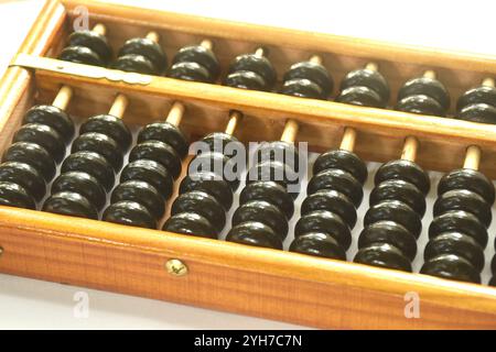 wooden abacus old Chinese tool for calcuated arraning on white background Stock Photo