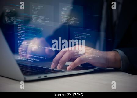 Hands typing on laptop with programming code on screen, representing software development. Perfect for coding, IT solutions, digital technology, web a Stock Photo