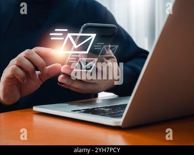 SMS sending, Email or message send, communication technology concepts. Fast moving of envelope, digital letter icons appearing while business person u Stock Photo