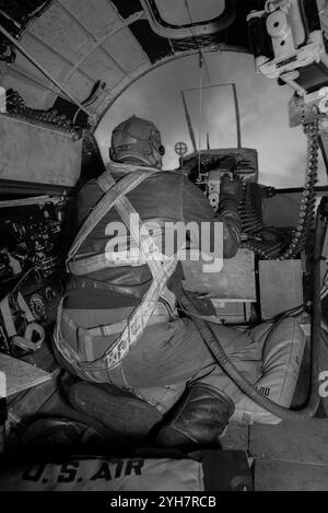 A bombardier manning the nose machine gun in a Boeing B-17A Flying Fortress, an American four-engined heavy bomber aircraft developed in the 1930s for the United States Army Air Corps (USAAC). The fast and high-flying bomber, the B-17 was used primarily in the European Theater of Operations and dropped more bombs than any other aircraft during World War II. It was primarily employed by the USAAF in the daylight component of the Allied strategic bombing campaign over Europe, complementing RAF Bomber Command's night bombers in attacking German industrial, military and civilian targets. Stock Photo