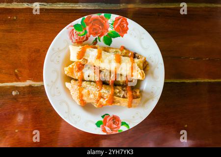Spring rolls and sauces on wooden table, selective focus Stock Photo
