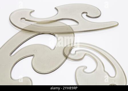 Retro transparent plastic french curve rulers on white background Stock Photo