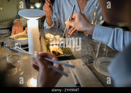 Elegant dining setting at modern Asian fusion restaurant with contemporary table design and atmospheric lighting Stock Photo